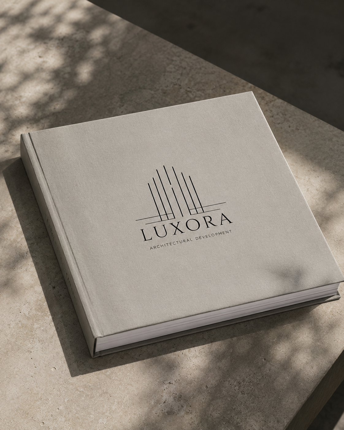 LUXORA linen-bound monograph with embossed emblem